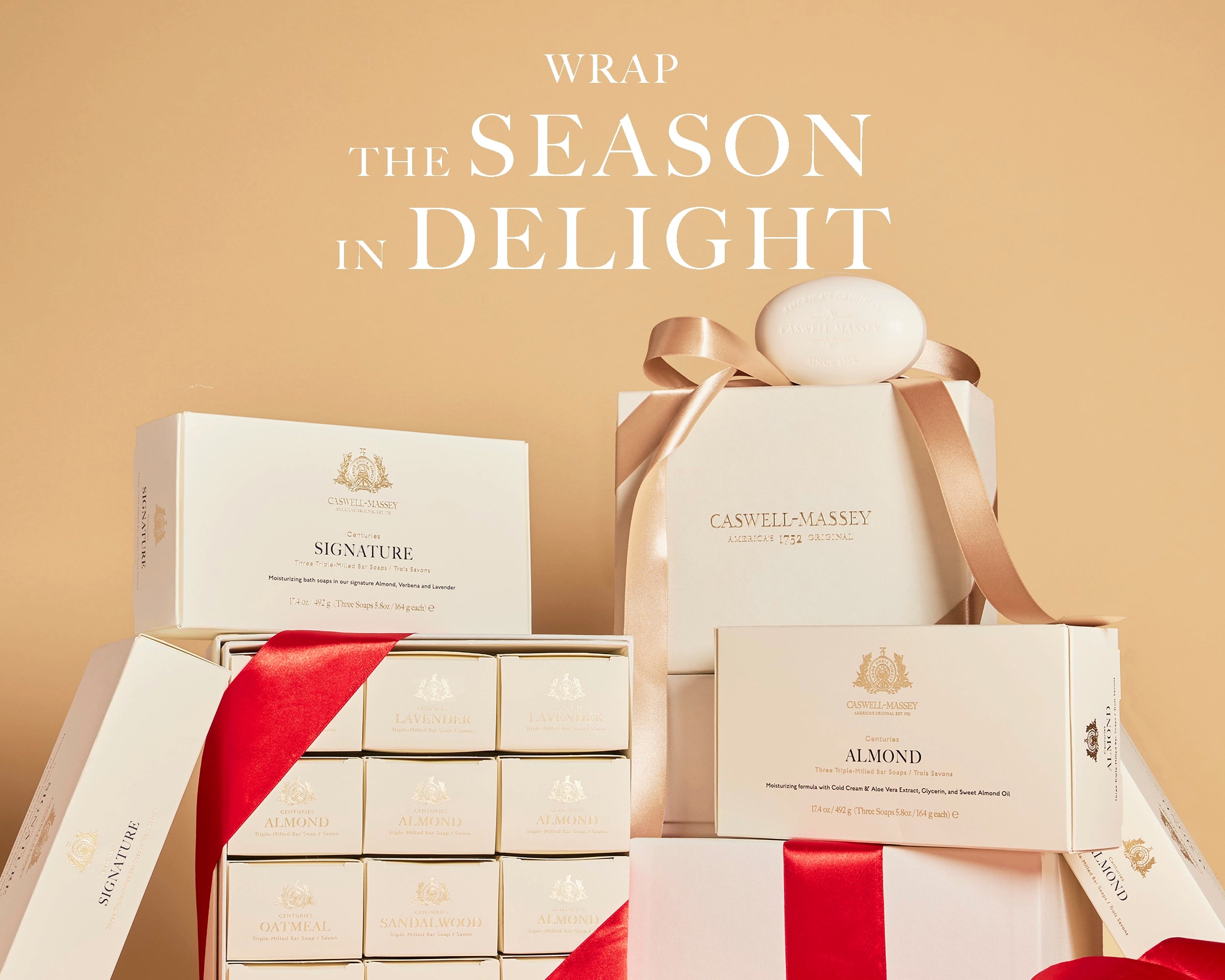 Caswell-Massey Women's Gift Sets. Image shows cream gift boxes stacked on top of one another wrapped with ribbons. Gift sets include Centuries Year of Soap, Almond 3-Soap Set, and women's Centuries Gift Set.